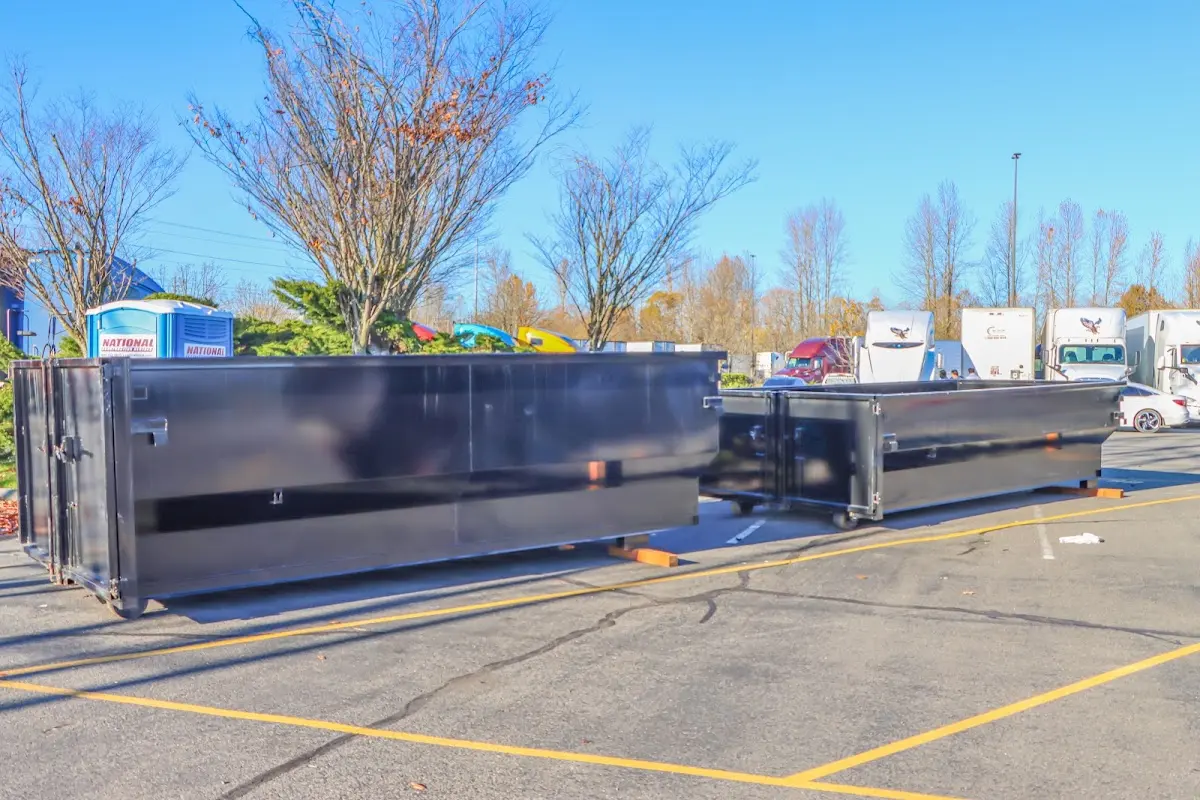 Professional dumpster rental service with roll-off container on residential driveway in Garden Acres